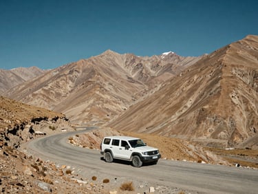 A clean private 4x4 vehicle parked safely on a dramatic curving mountain pass in Spiti Valley, vast dry mountains and deep blue sky in the background.