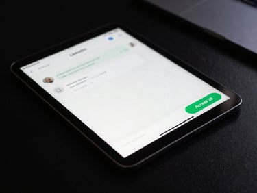 Close-up of a tablet on a dark desk showing a LinkedIn message conversation with a prominent green 'Accept' button. Moody side lighting, sharp focus.