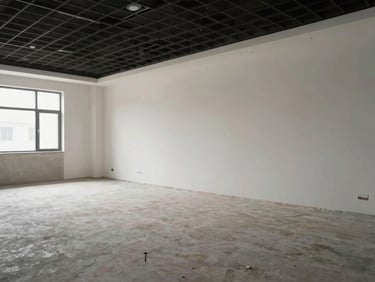 Interior fit-out completed space, natural light from windows, clean partition walls and ceiling grid installed, wide angle showing full room completion, no people
