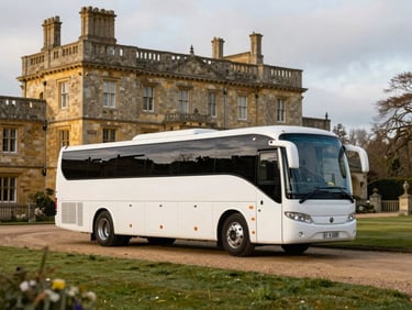A modern white 24-seater coach parked near a historic stone manor house in the UK countryside, soft golden hour lighting, 35mm