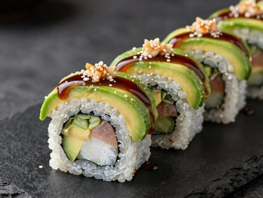 A dragon sushi roll with avocado wrapping and unagi sauce drizzle on a dark stone plate, professional food photography, North American / US.