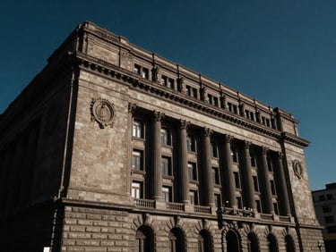 Low-angle dramatic architectural shot of a federal court house in Mexico City, high-contrast side lighting, deep navy tones, 35mm