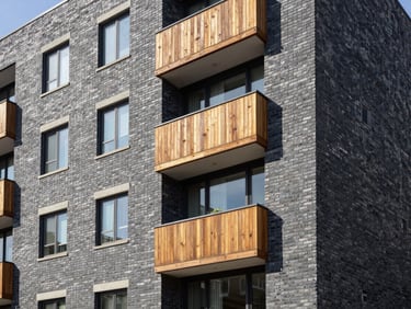 Detail of a well-maintained brick apartment building exterior, sharp focus, professional architectural photography.