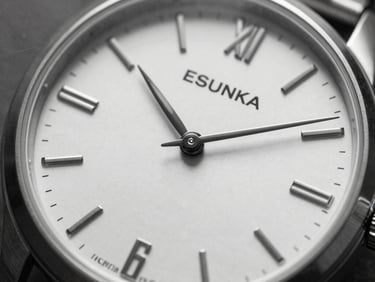 Close-up black and white shot of a minimalist watch face with a leather strap, sharp focus on metal and leather textures, high contrast, 35mm