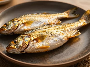 Close-up of premium plated Ivorian poisson braisé with golden alloco on a dark ceramic plate, editorial food photography, warm lighting