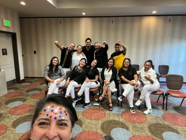 A diverse group of smiling professionals posing for a team photo at a corporate event or conference.