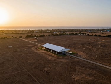 Aerial architectural photo of a vast land plot on the Route des Pêches, Benin, pristine coastal landscape, warm sunset light