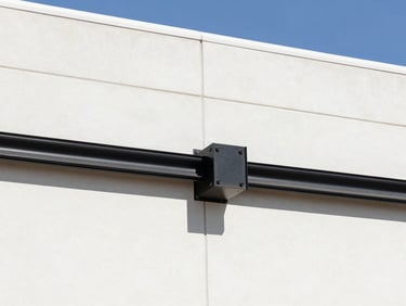Technical architectural detail of a heavy-duty elastomeric expansion joint on a commercial building facade, bright daylight, high-contrast.