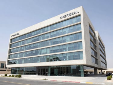 Wide-angle architectural photograph of Everseal's modern engineering office exterior in Dubai, clean concrete facade, bright daylight, professional corporate atmosphere.