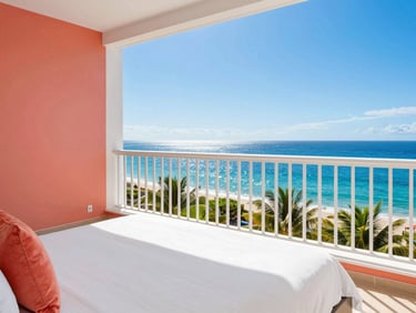Vibrant sunlit hotel room balcony with ocean view, white linens, coral accents, crisp saturated colors