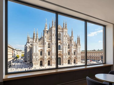 Bright modern hotel interior with large windows showing a historic European cathedral outside, high-clarity commercial style