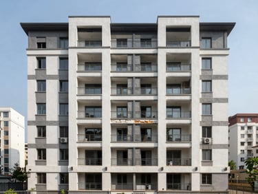 Residential flat exterior, mid-rise building facade, architectural detail showing condition and materials, daylight, wide sight lines including neighboring context, clear urban framing, no lifestyle staging