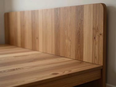 Close-up of a modular bedroom interior, warm timber veneer panel wall behind a low platform bed, north-facing diffused light, empty room, sharp material texture detail at edge of frame