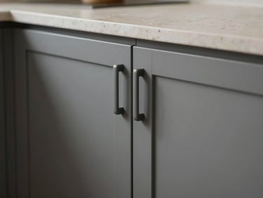 Close-up macro photograph of a premium modular kitchen interior, matte grey cabinet doors with integrated handles, stone-effect countertop surface detail, under-cabinet lighting strip, no people, even studio illumination