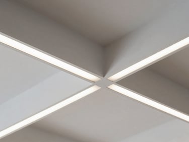Macro close-up of a false ceiling coffered grid with recessed LED strip lighting, clean white gypsum board surface, sharp edge detail, studio illumination, no people, architectural detail photography