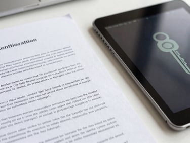A close-up macro shot of structured legal documents and a secure digital tablet displaying an abstract encryption key, bright professional daylight, clean organized desk surface.