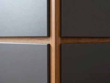 Extreme close-up of a flush cabinetry joint, matte charcoal panel meeting warm wood grain, soft daylight, architectural detail, 35mm
