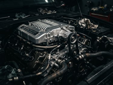 dark moody automotive photography, dramatic metallic highlights, close-up of a pristine Range Rover supercharged V8 engine block under repair, sharp focus, 50mm lens