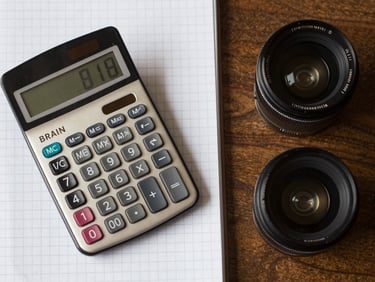 Top-down flat-lay of a perfectly organized workspace with a vintage Braun calculator and grid paper.