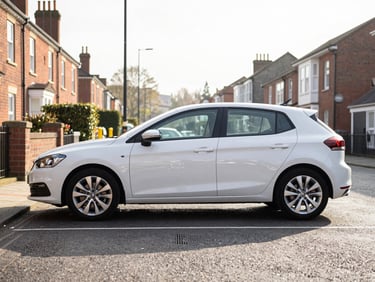 Modern automatic hatchback on a residential street in Shirley, Birmingham, UK, crisp morning sun, clean exterior car profile.