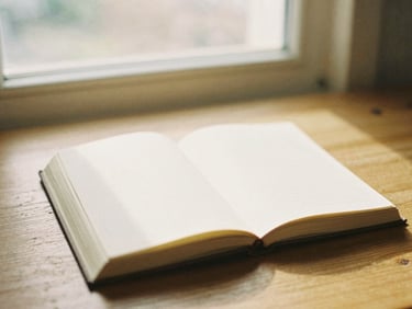 An open well-worn journal on a wooden table, soft morning window light, warm peaceful atmosphere, 35mm film look