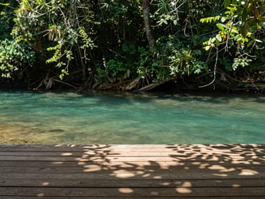 A quiet wooden deck overlooking a crystal clear turquoise river in Tamasopo, lush green foliage, soft natural light