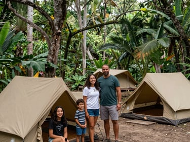 A family sitting in a circle on woven mats in a clearing, soft dappled jungle sunlight filtering through leaves, 35mm