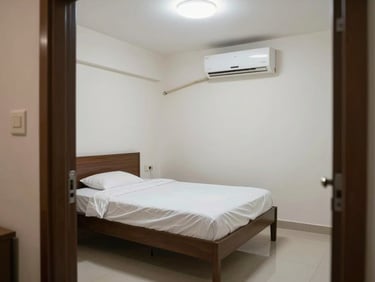 Boys PG room in Indirapuram — single bed with white linens, wall-mounted AC unit clearly visible, bright overhead light, clean tiled floor, shot from doorway corner, no people, documentary style