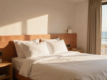 Bright sun-drenched suite room interior with terracotta accents, clean linens, warm morning light, 35mm lens