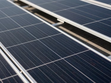Macro detail of high-end dark monocrystalline solar cells, clean geometric lines, metallic grid lines catching crisp daylight, premium architectural finish.