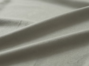 Abstract composition of soft, flowing fabric in muted tones, gentle light creating subtle shadows, serene and artistic