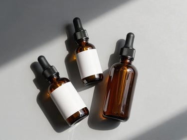 Overhead flat-lay of imported beauty and skincare products — two small bottles and a compact — on a light grey surface under clean studio daylight, no branding visible