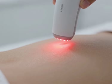 Macro shot of a high-tech LED device emitting a soft red light onto clean skin, clinical aesthetic, 35mm