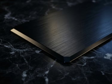 Macro close-up of a premium physical black metal card resting on dark Swiss marble, dramatic chiaroscuro lighting, subtle gold and blue ambient reflections.