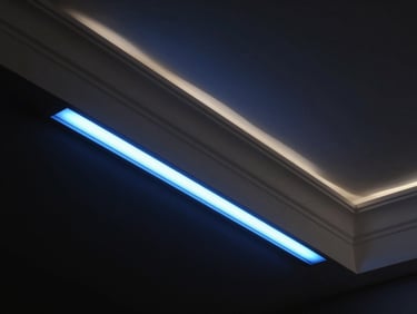 Extreme close-up of a recessed smart lighting strip casting a precise electric-blue glow along the underside of a ceiling cornice, architectural interior, near-black background, studio strobe highlight on the plaster edge
