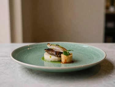 Artfully plated gourmet dish in a refined restaurant setting, soft lighting, focus on culinary detail, 35mm