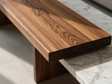 Macro shot of premium teak wood and white marble finishes inside a sunlit luxury penthouse.