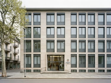 Bright overcast daylight architectural view of the Italian Consulate building in Lugano, structured clean composition, soft neutral tones, 35mm
