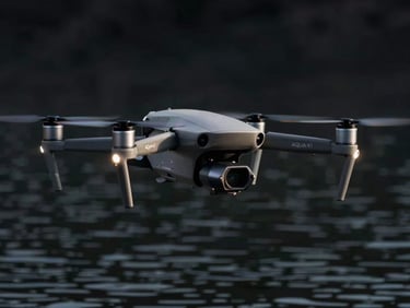 AQUA-X1 drone hovering over calm water, showing underside sensors, sharp edge-lighting, dark obsidian background.