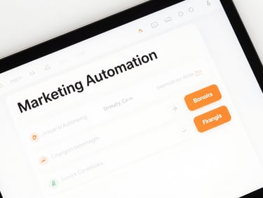 Close-up flat-lay of a marketing automation software dashboard interface on a bright white background, clean UI with orange accent buttons, studio-neutral lighting