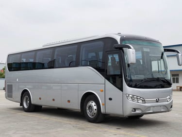 Three-quarter exterior profile of a modern 45-seat luxury AC coach, bright overcast daylight, clean metallic paint, sharp focus.