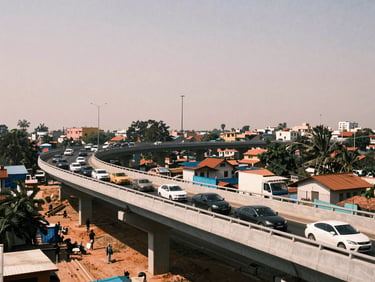 A wide shot of a newly constructed flyover in Mansarovar, traffic flowing underneath, harsh midday sun, realistic urban environment.