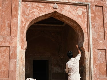 A close-up of local artisans working on restoring a stone archway in Jaipur, natural daylight, warm terracotta tones.