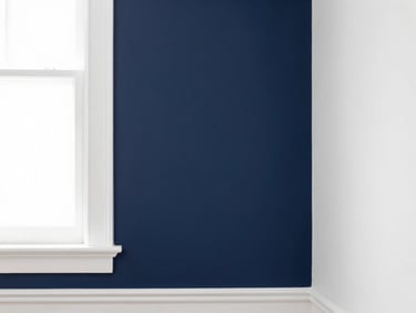 Bright architectural photography of a freshly painted navy accent wall meeting crisp white trim, clean natural window light, crisp high-contrast tones, sharp focus, 35mm