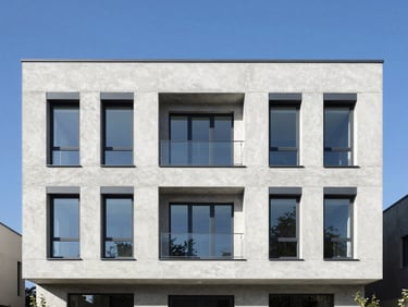 Straight-on architectural elevation of a modern concrete house facade under bright daylight, high contrast