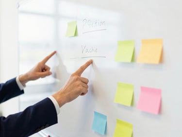 Bright editorial photography of a structured whiteboard with meeting notes, hands pointing to action items, vibrant professional tones.