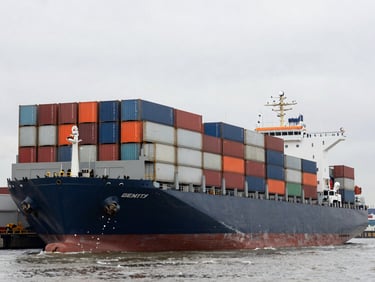 A massive container ship being loaded with commercial trucks at a busy industrial port, overcast daylight, 35mm