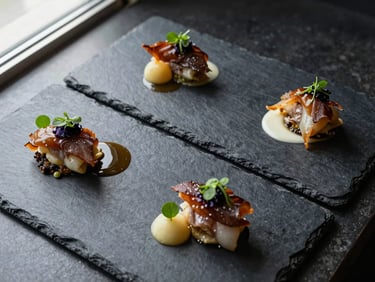 Overhead close-up of three individual fine-dining courses plated on dark slate, precise sauce work, garnish placed with exactness, natural window light from the side, no hands in frame