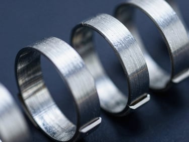 Macro close-up of heavy-duty interlocking hose clamps, high-contrast industrial lighting, steel reflections, 35mm