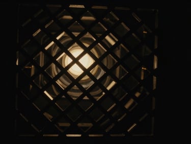 Abstract light refractions and intricate geometric patterns, dark cinematic photography, subtle gold ambient glow.
